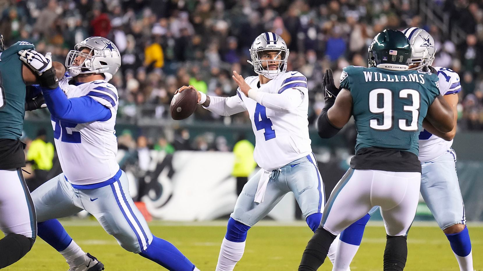 Dallas Cowboys quarterback Dak Prescott (4) throws a 14-yard touchdown pass with protection from guard Connor Williams (52) and offensive tackle Terence Steele (78 during the first quarter of an NFL football game against the Philadelphia Eagles at Lincoln Financial Field on Saturday, Jan. 8, 2022.