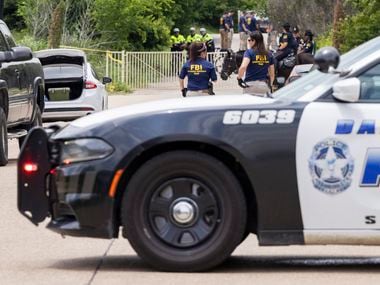 Dallas police and the FBI work the scene where a toddler boy was found dead early Saturday, May 15, 2021.