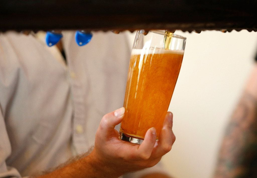 Beer glass is filled for a customer at Family Business Beer Company in Dripping Springs,...