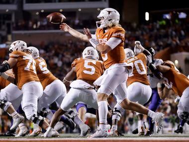 Texas Longhorns quarterback Quinn Ewers (3) whips a pass to his left against the TCU Horned...