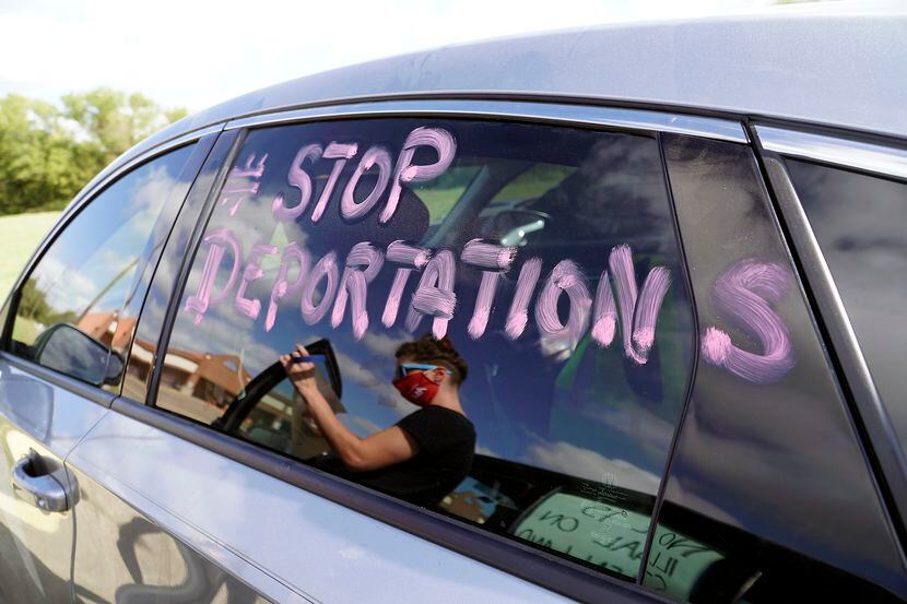 Immigrant advocates decorated their cars with signs in preparation to protest at the...