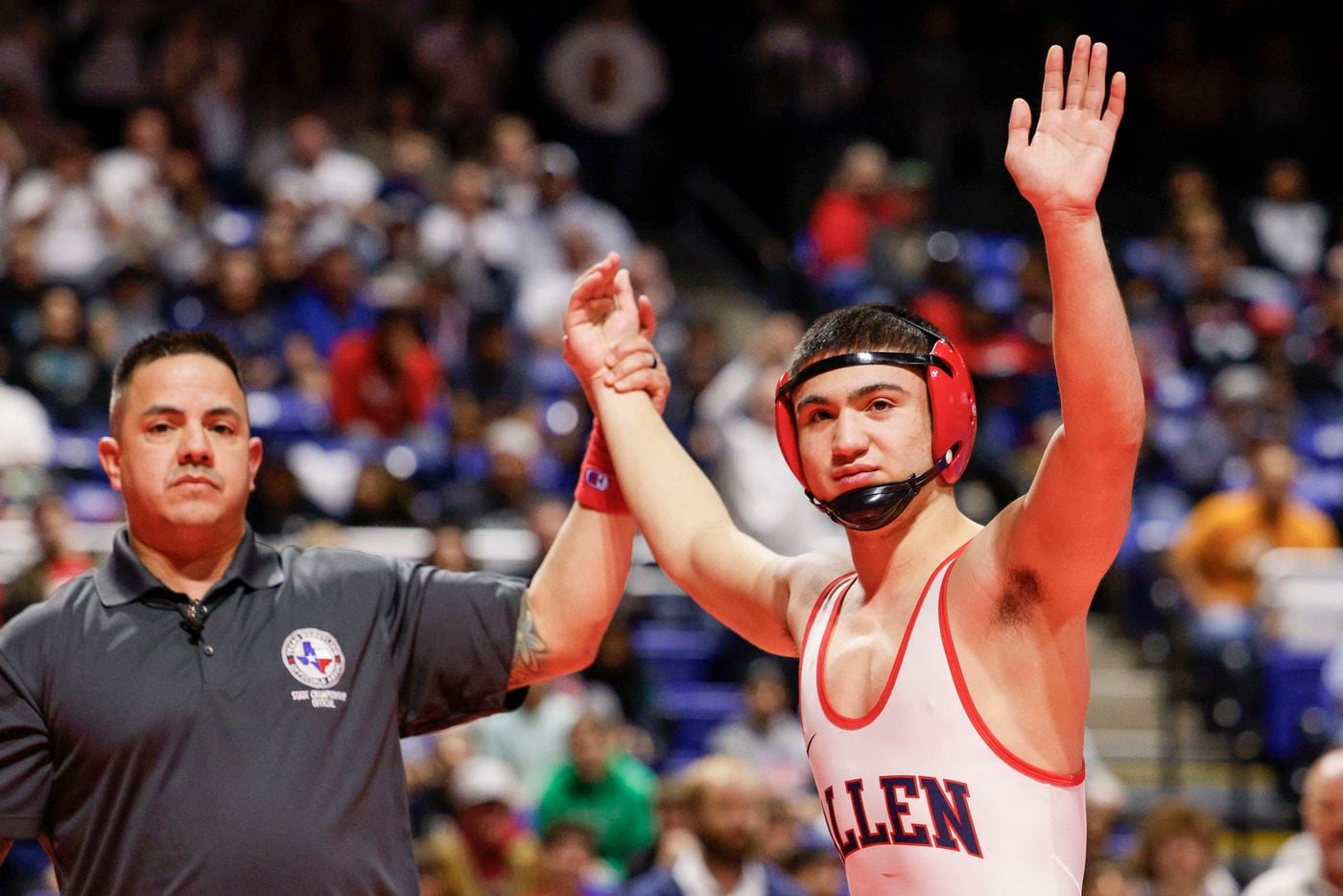 Kade Moore of Allen waves to the crowd after winning the 6A boys 138-pound UIL State...
