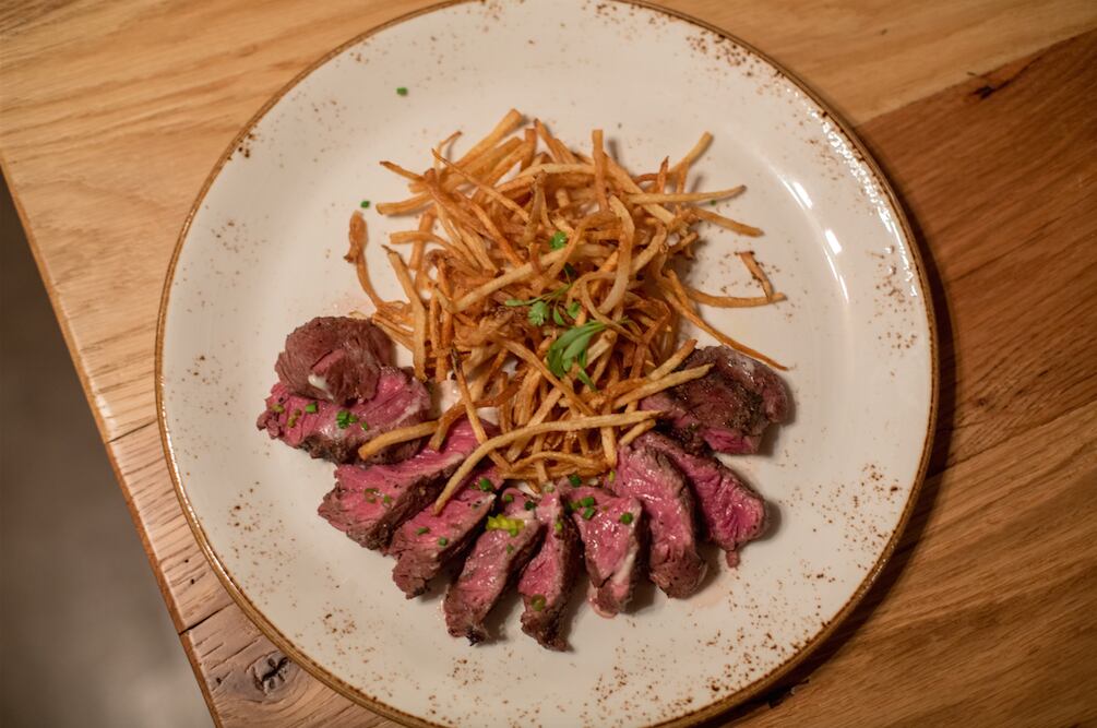 Hanger Steak served with matchstick fries and soaked in truffle butter, at Barley and...