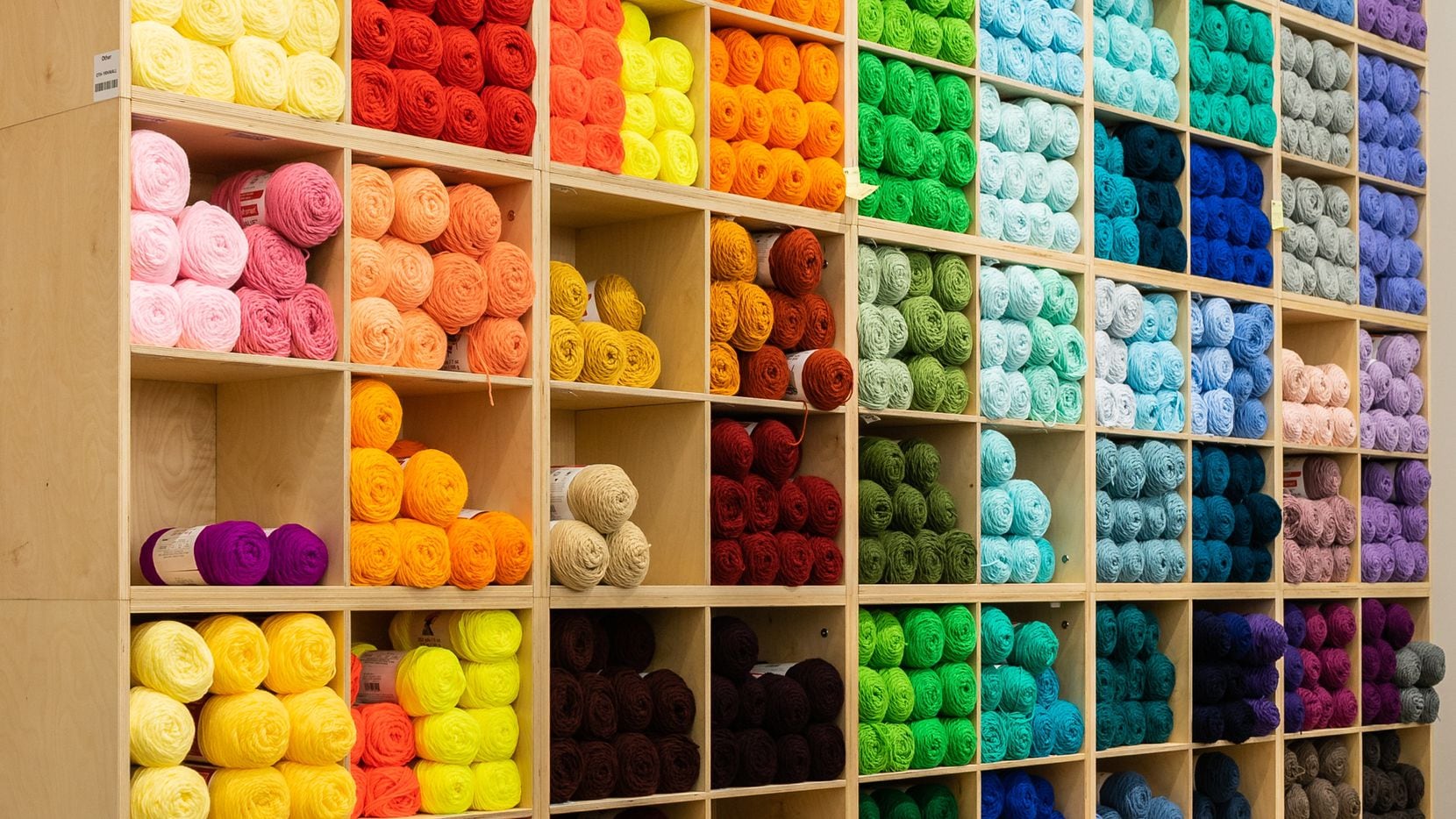 Wall of yarn at a Michaels arts and crafts store.