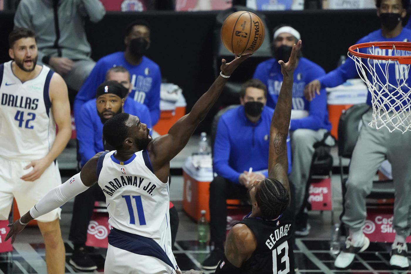 Dallas Mavericks forward Tim Hardaway Jr. (11) has a shot blocked by LA Clippers guard Paul George (13) during the first half of an NBA playoff basketball game at Staples Center on Tuesday, May 25, 2021, in Los Angeles.