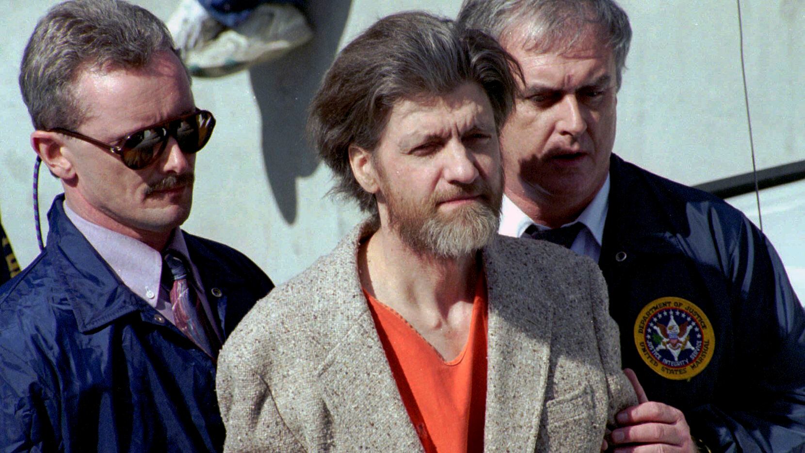 Ted Kaczynski, better known as the Unabomber, is flanked by federal agents as he is led to a...
