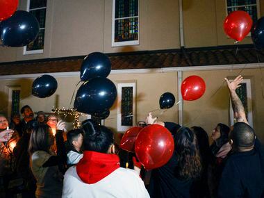 Friends and family members of Zechariah Trevino, 17, release balloons after a candlelight...