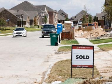 A sold sign in front of new houses in Woodcreek neighborhood, the largest housing...