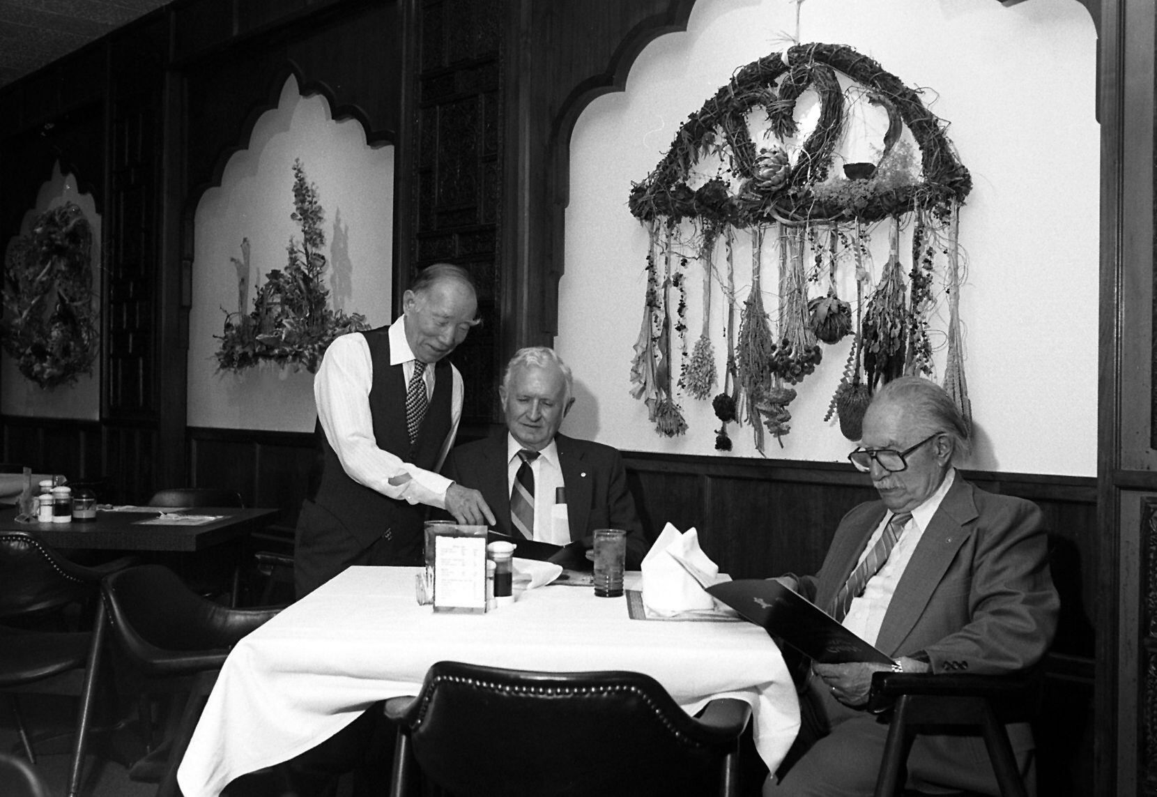 Shu-Chang "Buck" Kao discussing Royal China's menu with customers on March 30, 1995