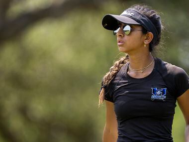 Hebron’s Symran Shah watches her shot from the 9th tee box during the 6A girls state golf...