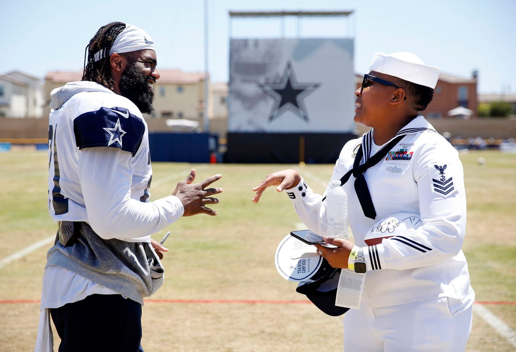 Dallas Cowboys running back Ezekiel Elliott (21) signs an autograph for Navy recruiter...