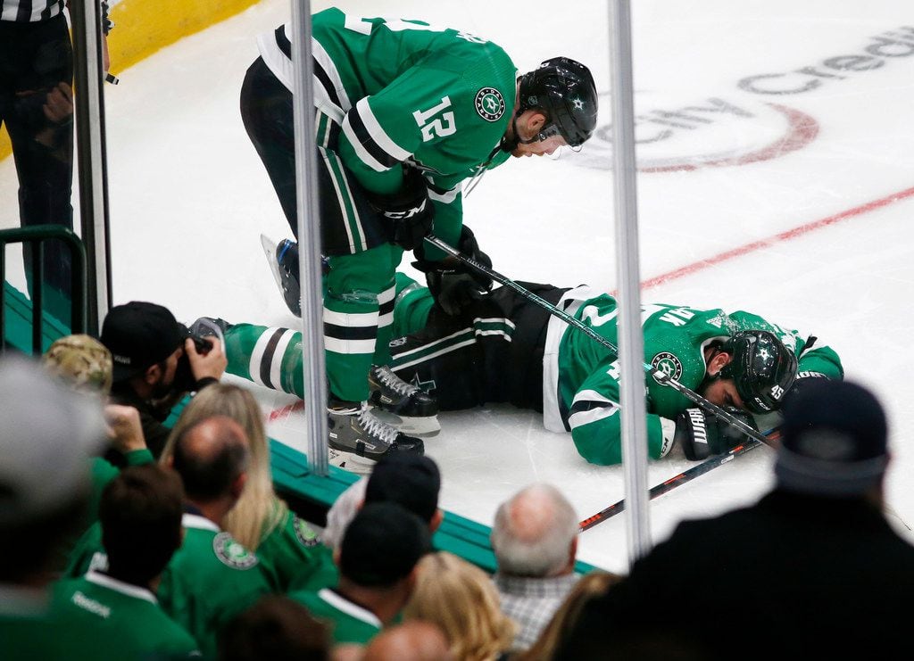 Dallas Stars center Radek Faksa (12) checks on injured player Dallas Stars defenseman Roman Polak (45) during the second period of play in the home opener at American Airlines Center in Dallas, Thursday, October 3, 2019. (Vernon Bryant/The Dallas Morning News)
