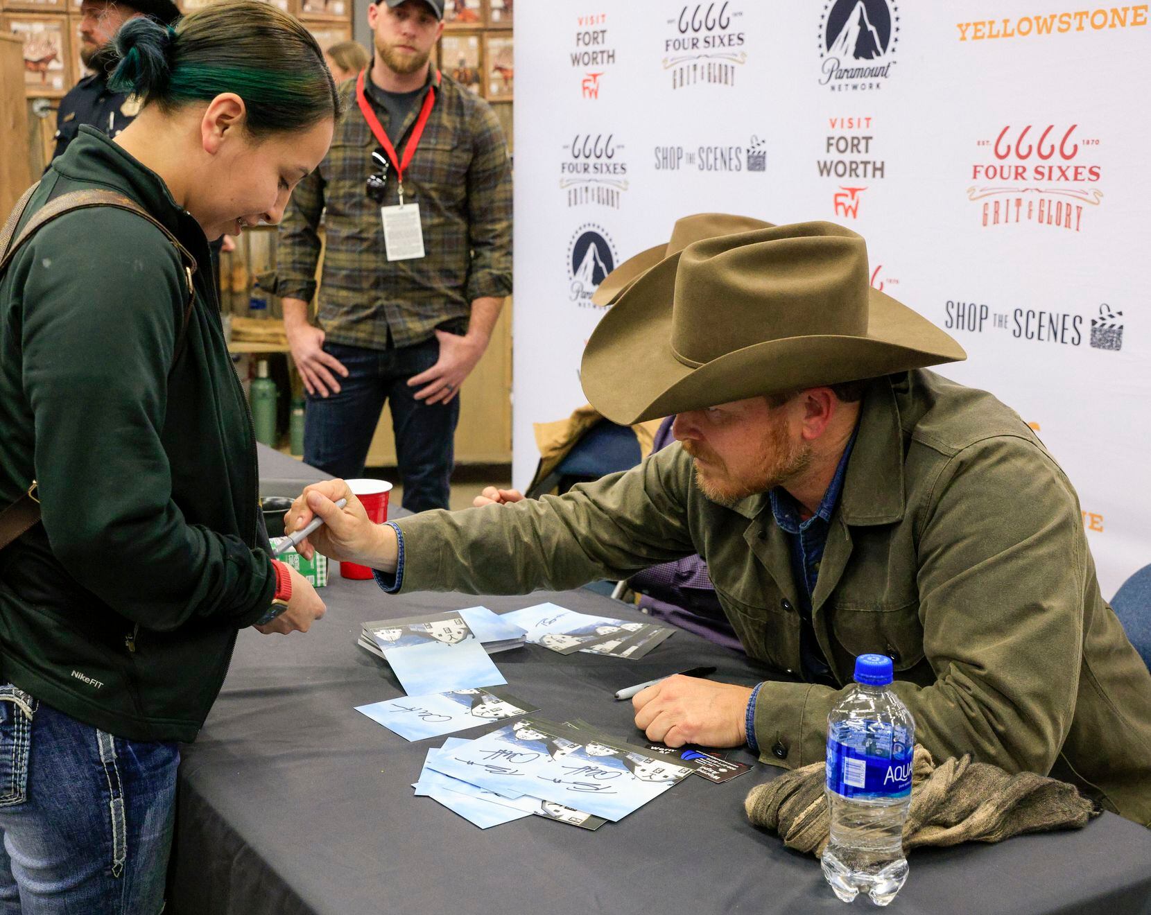 “Yellowstone” actor Cole Hauser signs the shirt of Tanya Garza.