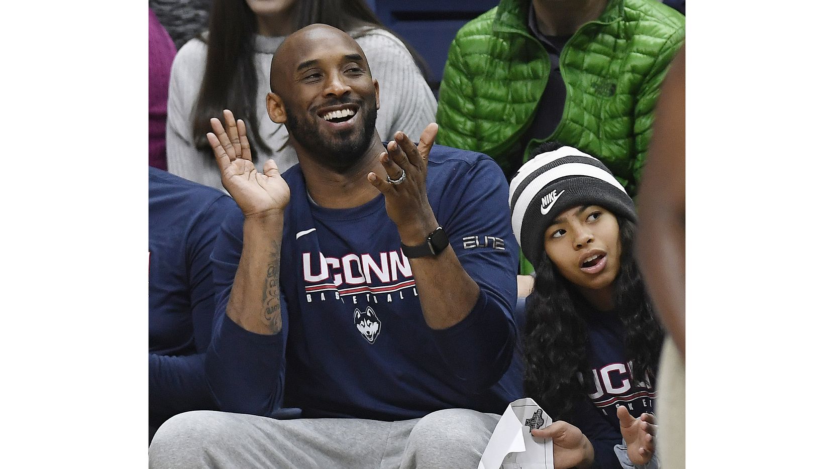 In this March 2, 2019 photo, Kobe Bryant and his daughter Gianna watch the first half of an NCAA college basketball game between Connecticut and Houston in Storrs, Conn. Dads with daughters inspired by Kobe Bryant's special bond with his 13-year-old Gianna took to social media to celebrate their own daughters in words and photos using the hashtag #GirlDads. Bryant and his daughter died in a helicopter crash on Sunday, Jan. 26, 2020.