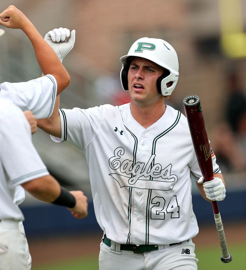 Prosper outfielder Jacob Devenny (24) gets congratulated after scoring a run against Coppell...