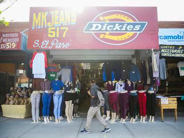 Shoppers pass by clothing stores along El Paso Street in downtown El Paso, Texas, on Monday,...
