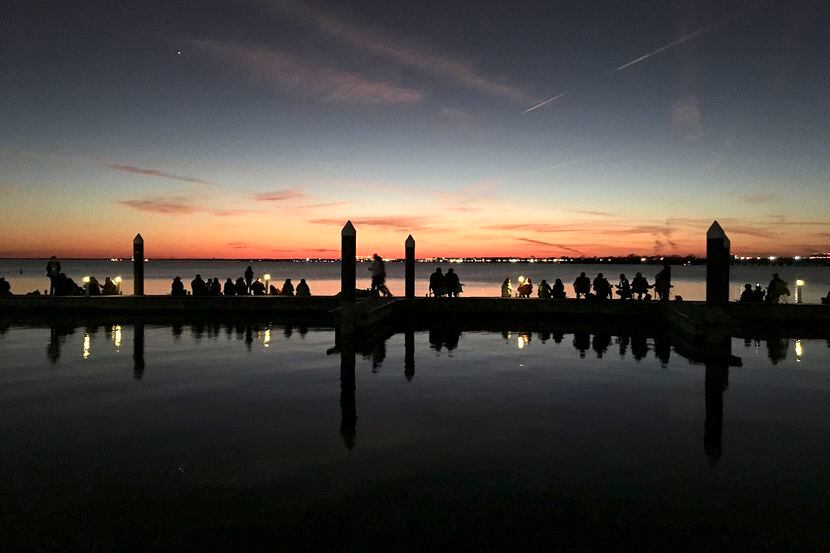 People lined the harbor docks to watch a sunset Dec. 14, 2019, over Lake Ray Hubbard in...