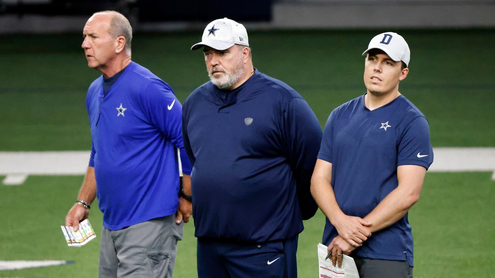 Dallas Cowboys head coach Mike McCarthy (center) and offensive coordinator Kellen Moore...