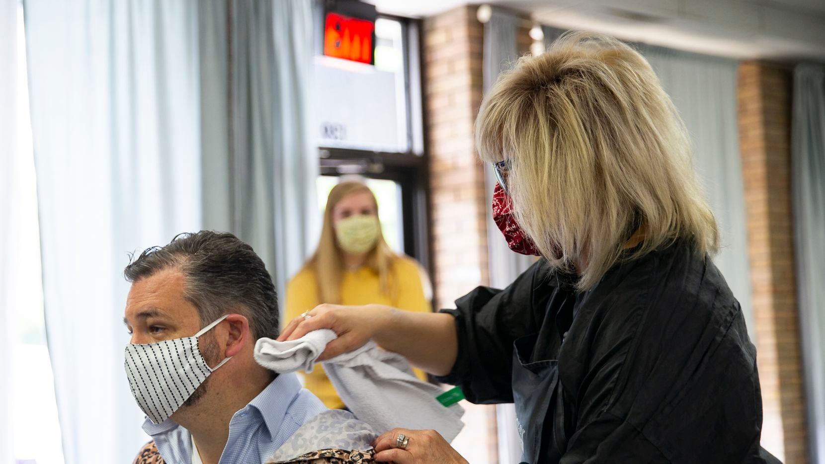 U.S. Sen. Ted Cruz, left, gets a haircut at Salon a la Mode on May 8, 2020 in Dallas. The...