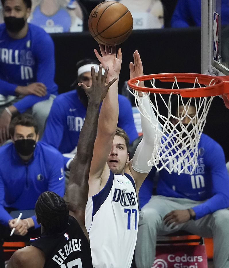 Dallas Mavericks guard Luka Doncic (77) shoots over LA Clippers guard Paul George (13) during the first half of an NBA playoff basketball game at Staples Center on Tuesday, May 25, 2021, in Los Angeles.