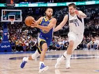 Golden State Warriors guard Stephen Curry (30) races past Dallas Mavericks guard Luka Doncic...