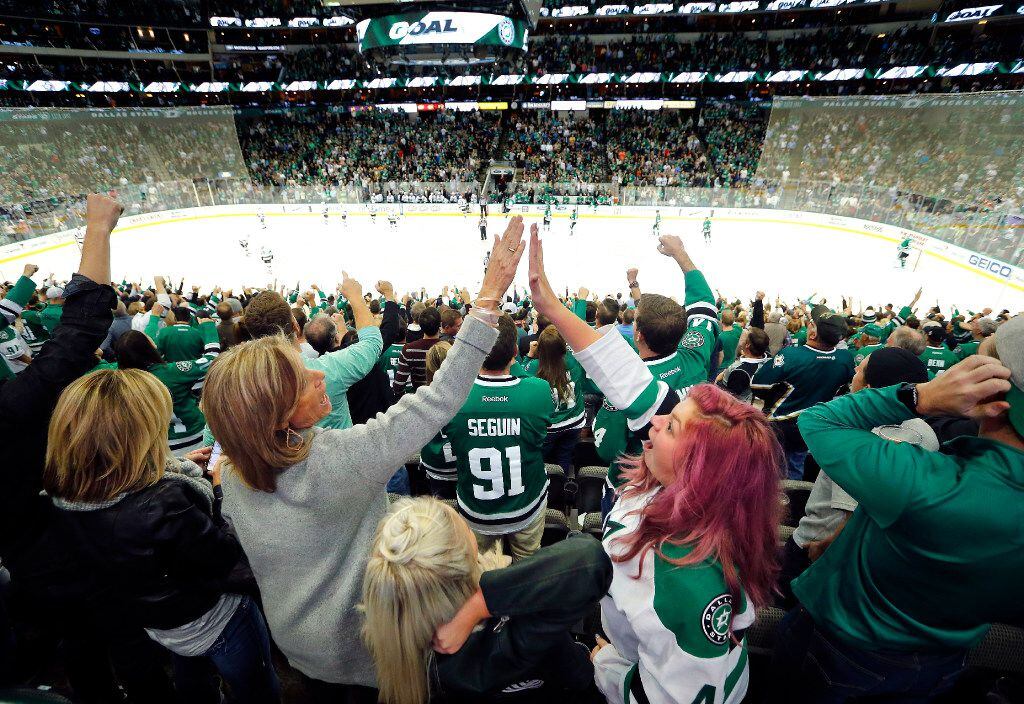 Gaye Ruff (left), wife of head coach Lindy Ruff, high-fives Lindsey Lally of Dallas after...