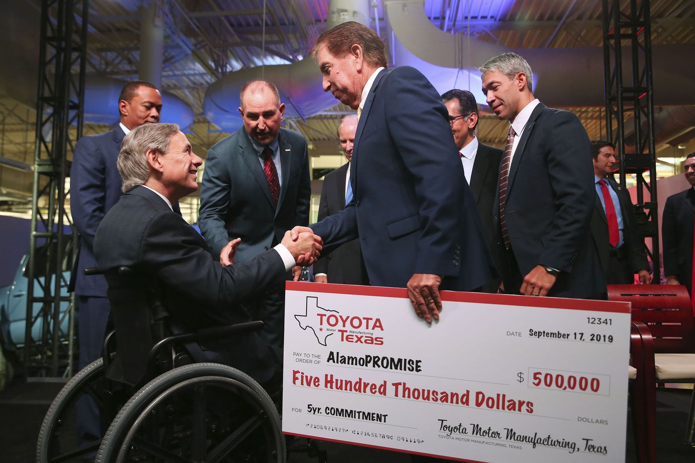 Alamo Colleges District Board of Directors Vice-President Joe Alderete, Jr. shakes hands with Texas Gov. Greg Abbott after an event announcing a $391 million expansion at the San Antonio Toyota plant, Tuesday, Sept. 17, 2019. The district's AlamoPROMISE program will received a $500,000 commitment from Toyota. 