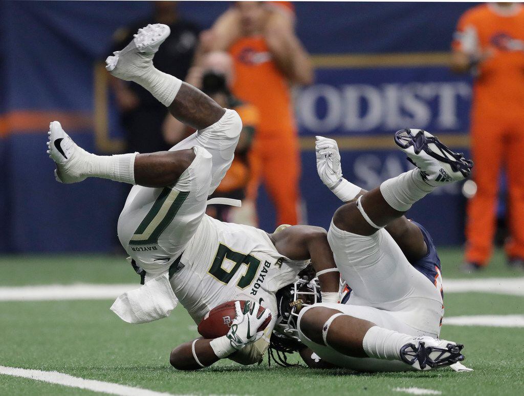 Baylor running back JaMycal Hasty (6) is upended by UTSA defensive tackle Kevin Strong Jr.,...