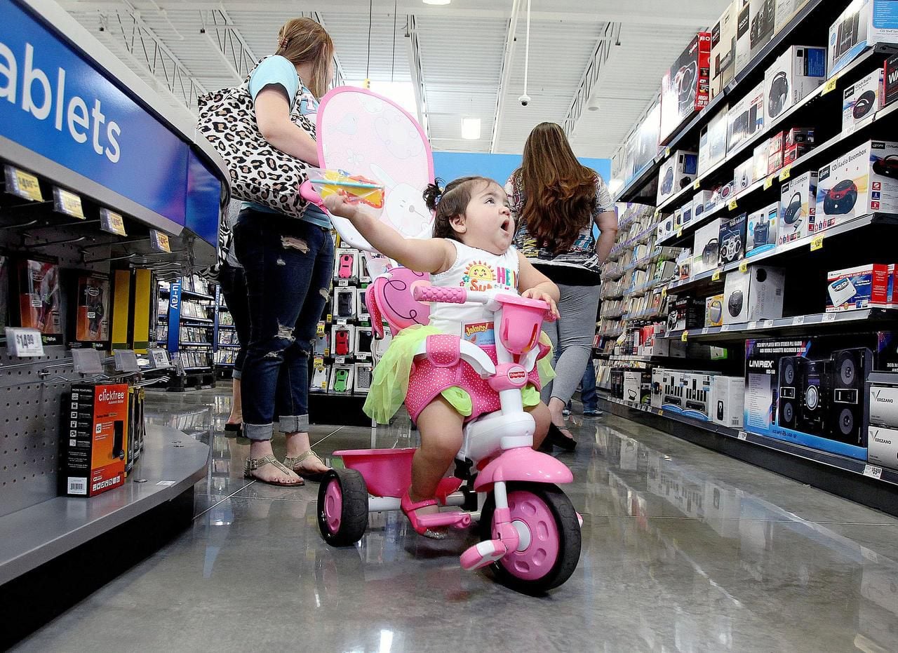 
As her mother shops, Kamila Coronado, 1, is dazzled by the electronics on the shelves of an...