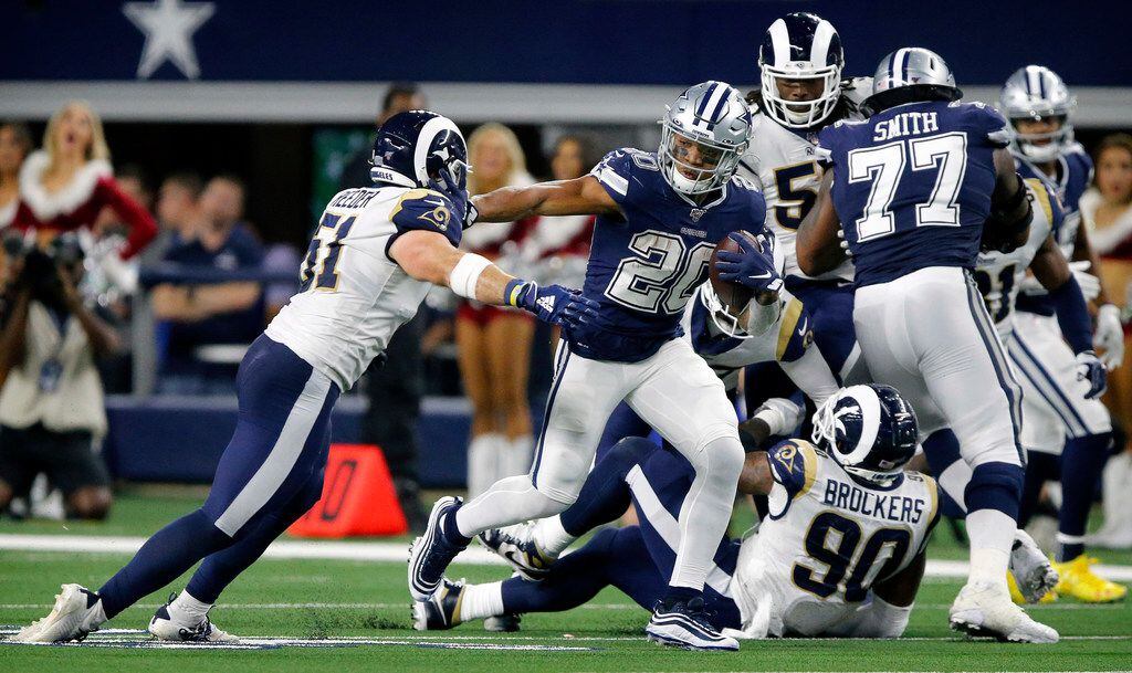 Los Angeles Rams linebacker Troy Reeder (51) attempts to tackle Dallas Cowboys running back Tony Pollard (20) during the fourth quarter at AT&T Stadium in Arlington, Texas, Sunday, December 15, 2019. Pollard broke several tackles as he carried the ball. The Cowboys defeated the Rams, 44-21.