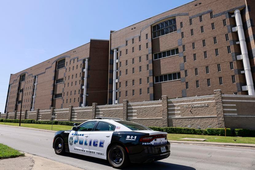 A Dallas police patrol car drives along Commerce Street outside the Dallas County jail ion...