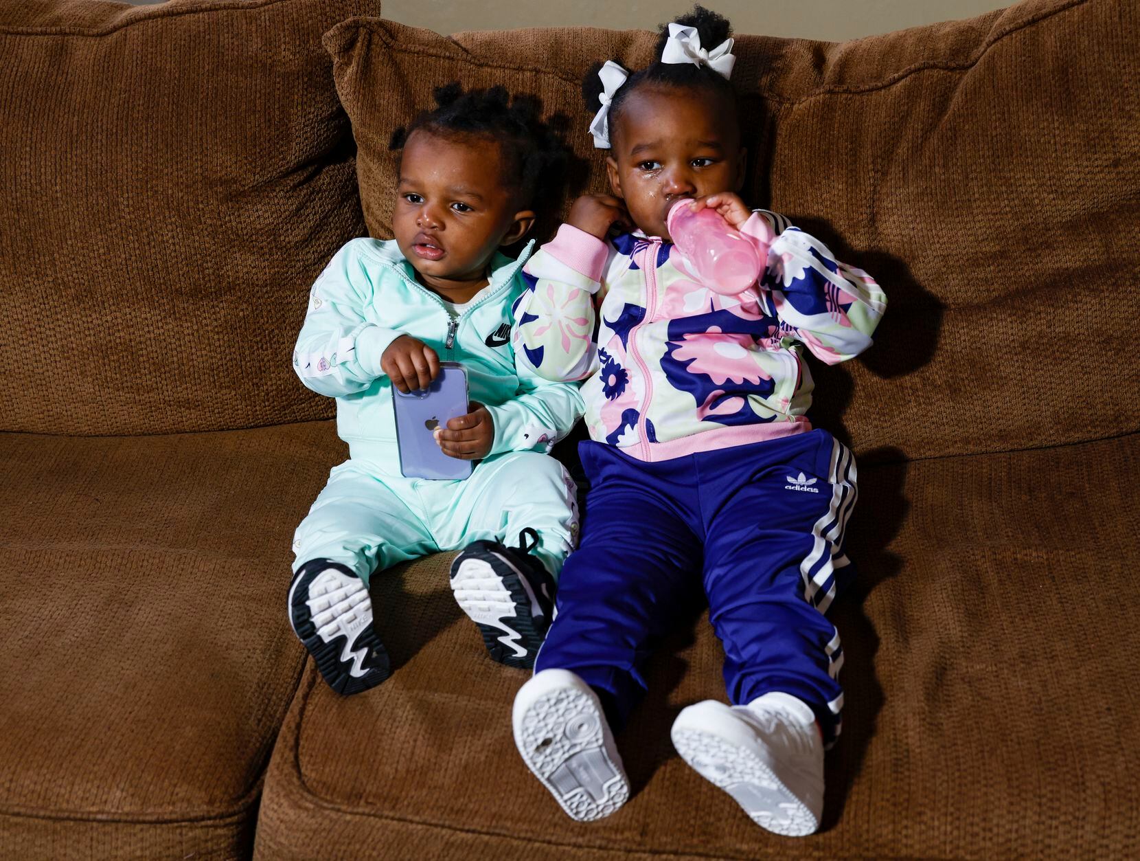 Daughters of Brionne Williams, Kenylaa, 1, and Kenzie, 2, pose for a portrait Friday in...
