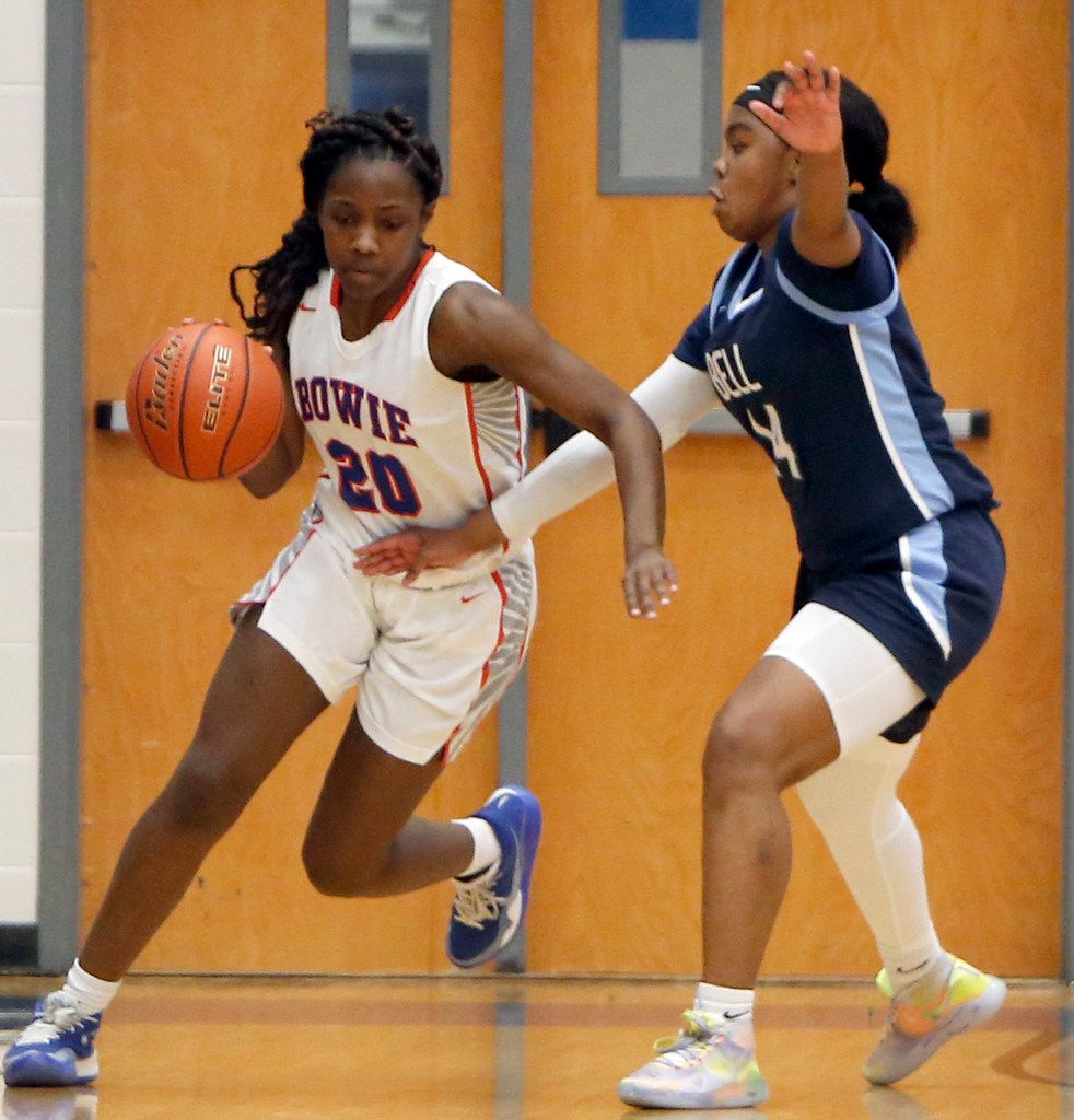 Arlington Bowie forward Aleyah Simmons (20) works to dribble around the defense of Hurst...