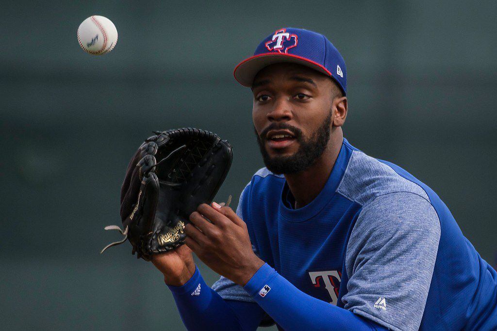 Texas Rangers pitcher Taylor Hearn participates in fielding practice during the first...