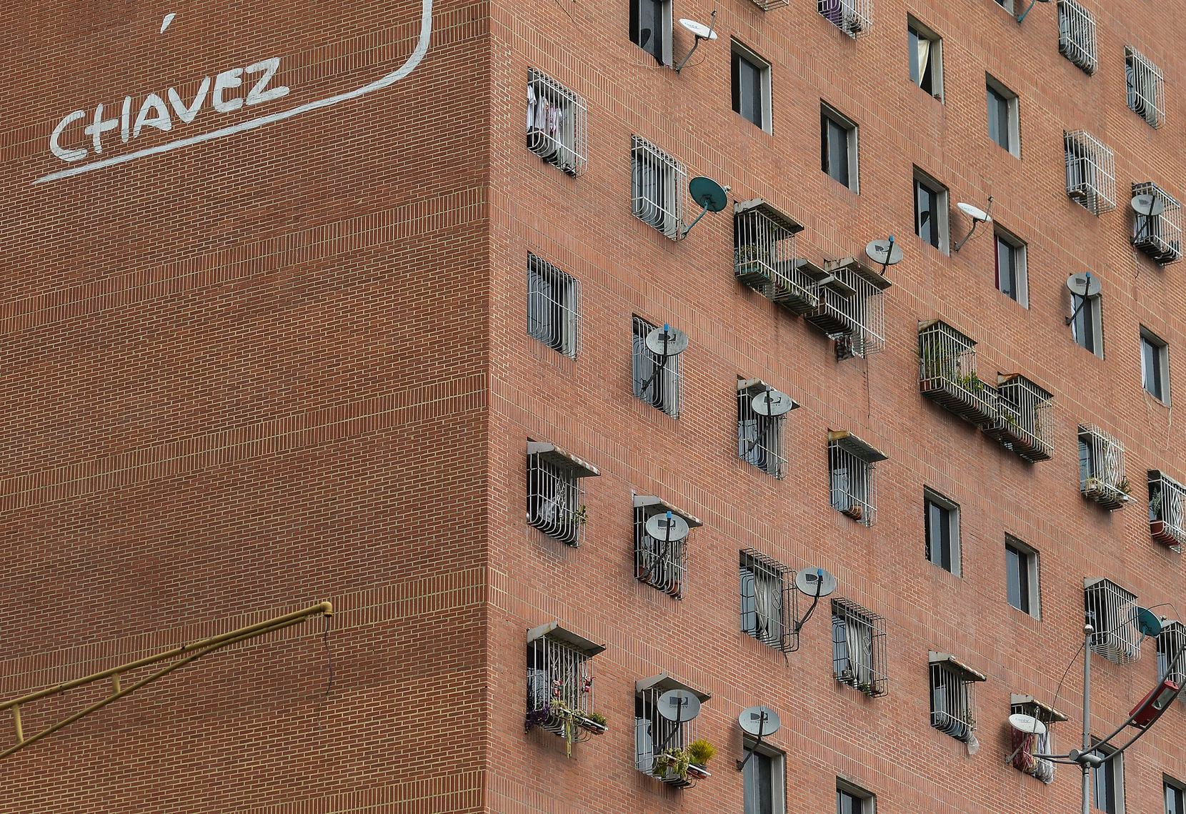 In this Jan. 9, 2020 photo, DirectTV dish antennas cover the exterior wall of an apartment...