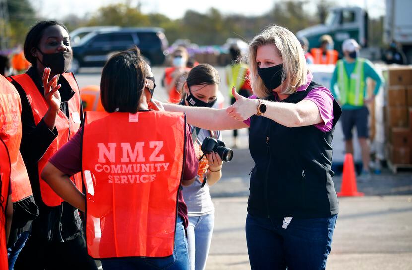 North Texas Food Bank president and CEO Trisha Cunningham gave a supportive thumbs-up to...