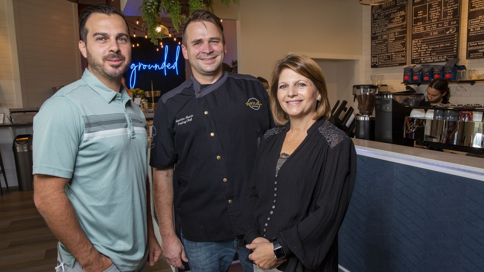 Grounds & Gold Coffee Co. co-owners Maurice Ahern with brother-in-law and mother-in-law, Jimmy and Jenifer Kinley pose for a photo in their cafe on Sept. 14, 2020 in Arlington. The coffee shop is an ode to Maurice's son Micah, who died from cancer four years ago.