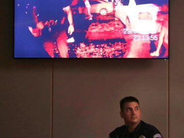 Officer Tyler Gross watched body-cam footage during his testimony on the first day of the...