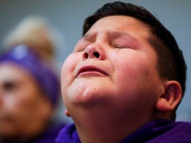 A tear drop rolls down the cheek of Ayden Robles, 10, step brother of late Grabiel Zamora,...