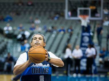 DISD superintended Dr. Michael Hinojosa shoots baskets on the floor before the first half of...