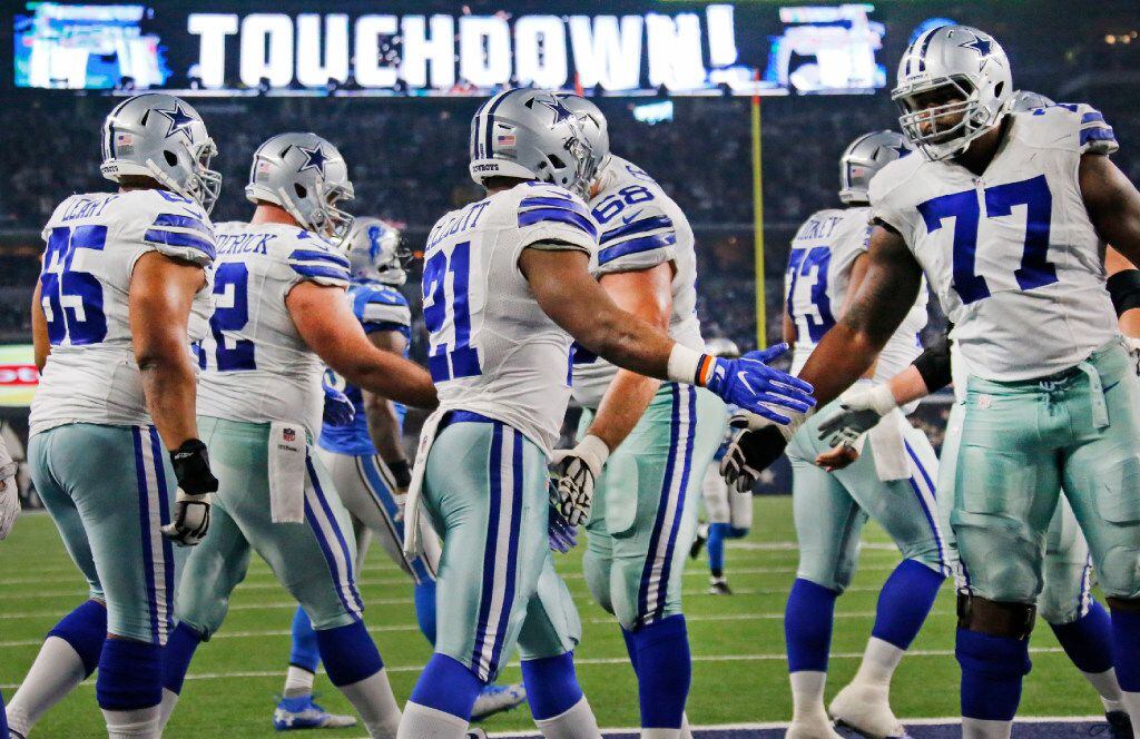Dallas Cowboys tackle Tyron Smith (77) congratulates Dallas Cowboys running back Ezekiel...