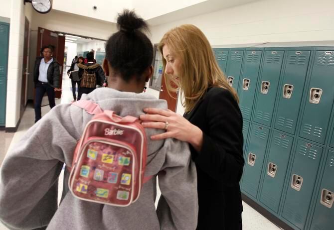 
Principal fellow Lesley Austin talks with an eighth-grader before the class at the Ann...