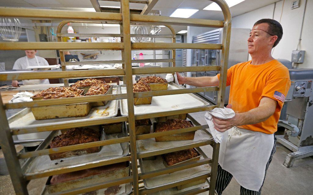 Cutshall pulls trays of freshly baked bread from the oven.