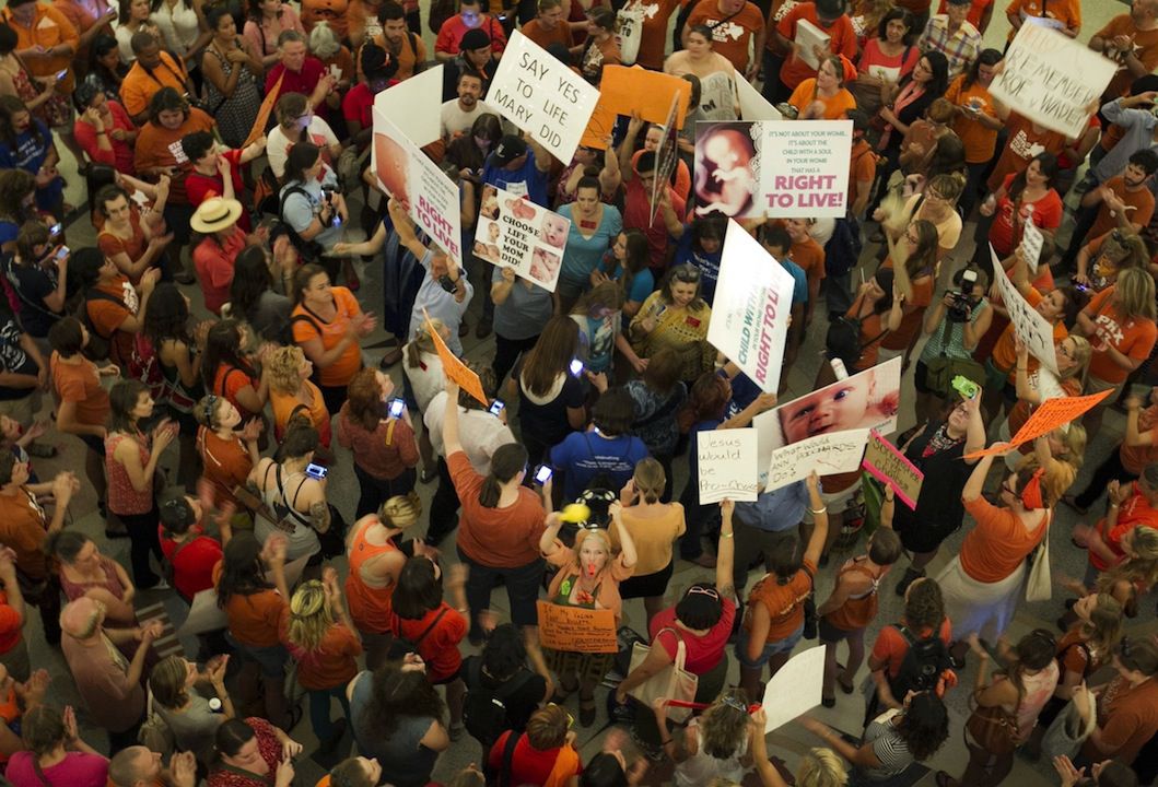  People on both sides of the abortion debate gather during the Senate's debate on Friday...
