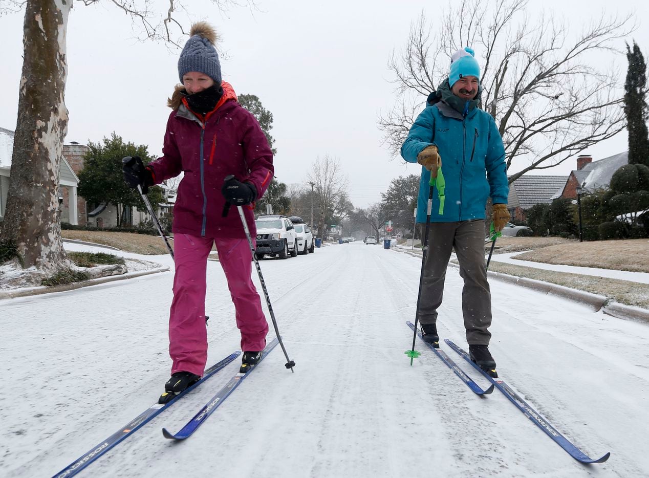 With the afternoon temperature hovering around 18 degrees F, with a wind chill of 4, Caroline and Peter Clark, of East Dallas, embrace the snowy Valentines Day weather by cross country skiing together in their Cochran Heights neighborhood, Sunday, Feb. 14, 2021 in Dallas. As temperatures dropped to near-record lows Sunday, electricity operators warned that demand could overwhelm the state’s power grid and force rotating power outages.