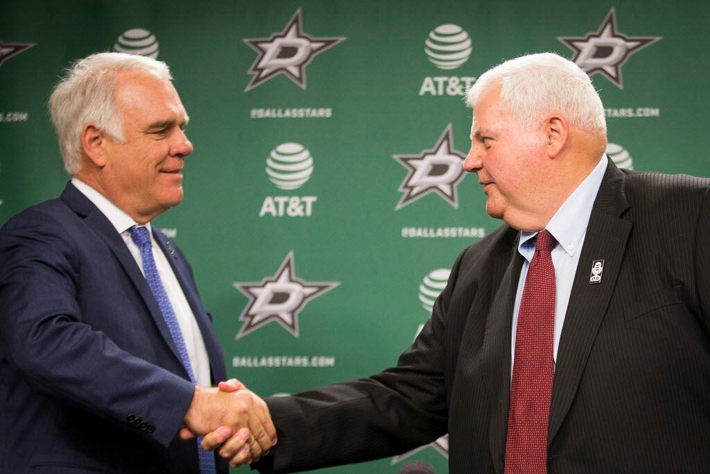 Ken Hitchcock shakes hands with team president Jim Lites (left) as he is introduced as the...