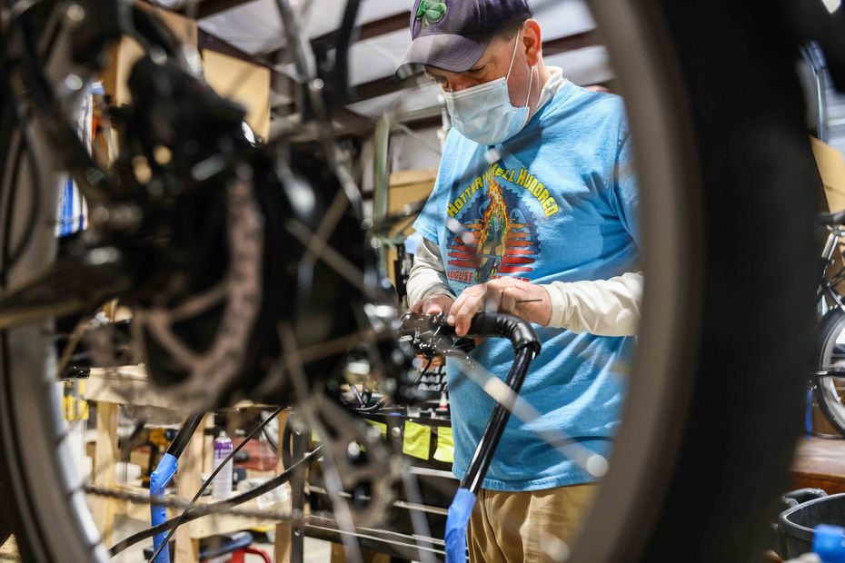 Tin Courtney assembles a bike at Bunch Bikes in Denton on Wednesday, March 24, 2021. (Lola Gomez/The Dallas Morning News)