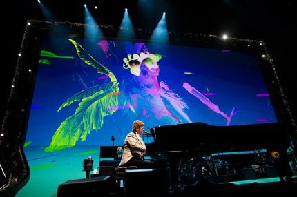 Elton John performs "Bennie and the Jets" at American Airlines Center in Dallas on Friday,...
