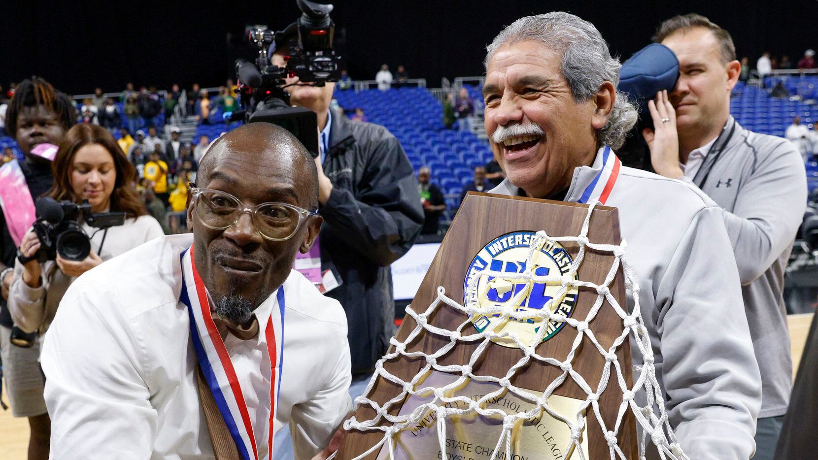 Madison boys basketball coach Damien Mobley (left) accepts the Class 3A state championship...