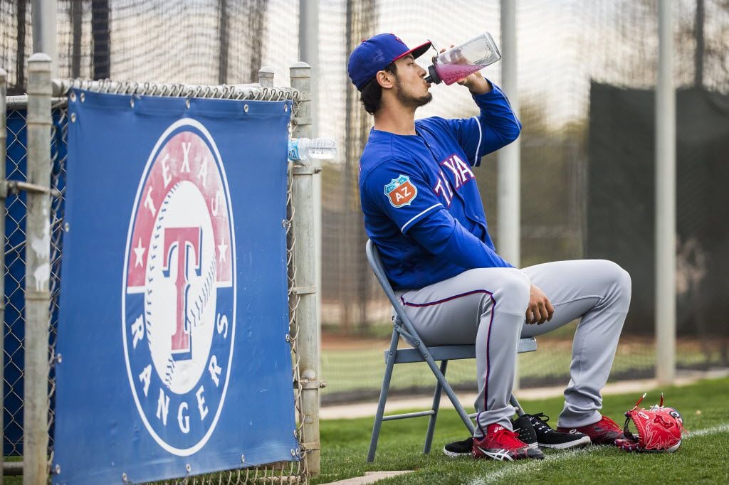Texas Rangers pitcher Yu Darvish takes a break to hydrate during the first full spring training workout for pitchers and catchers at the team's training facility on Friday, Feb. 19, 2016, in Surprise, Ariz.  (Smiley N. Pool/The Dallas Morning News)